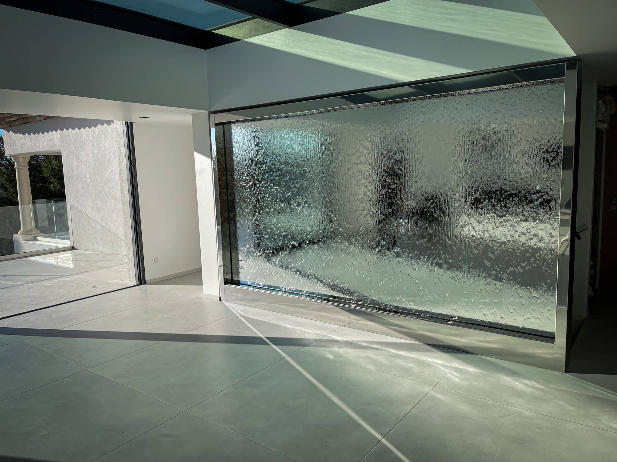 Large water wall at the entrance to a reception space
