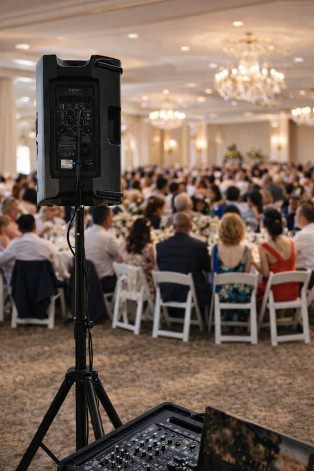 Speaker on a stand at the edge of a dining room