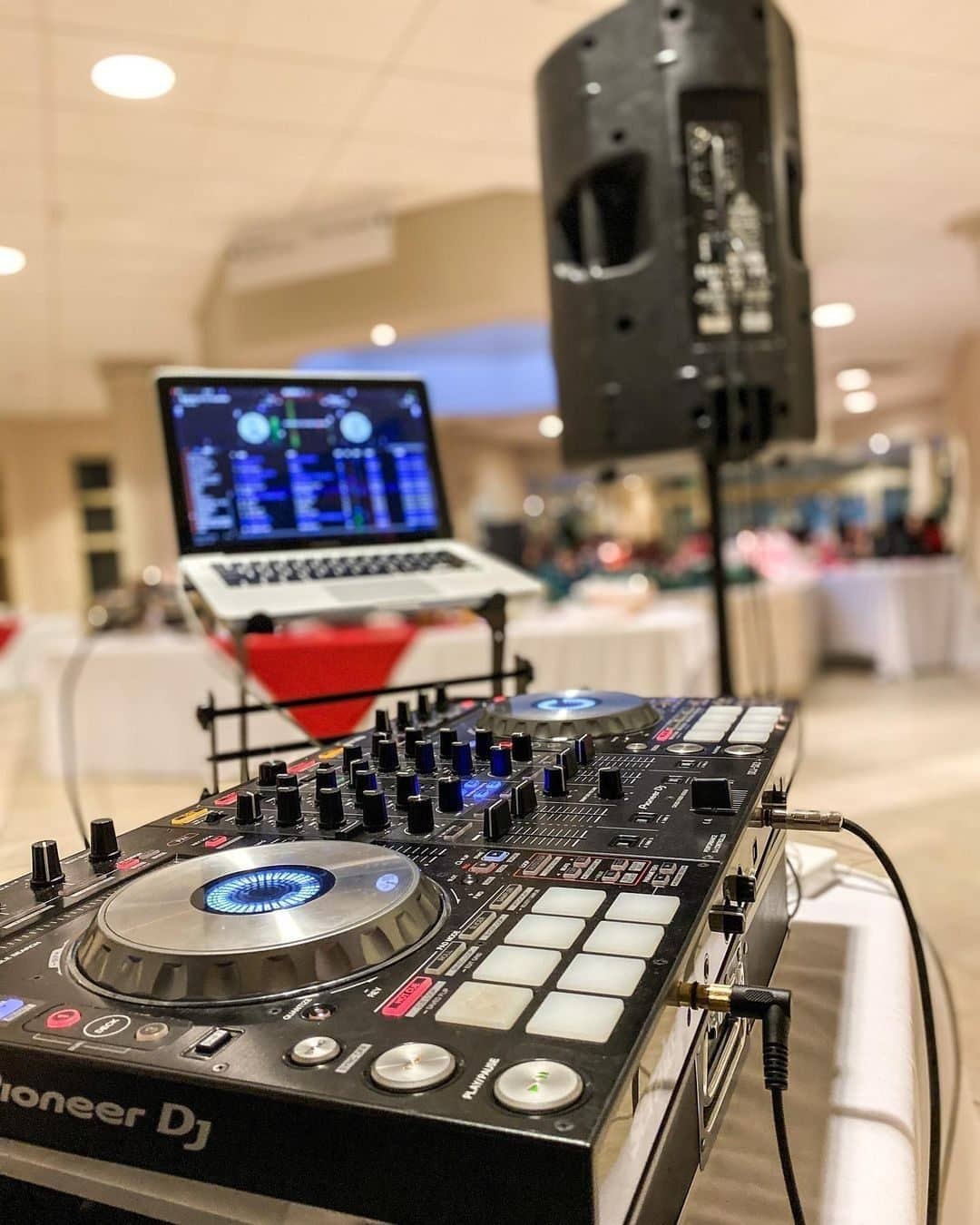 Speaker and DJ controller set up in a side room