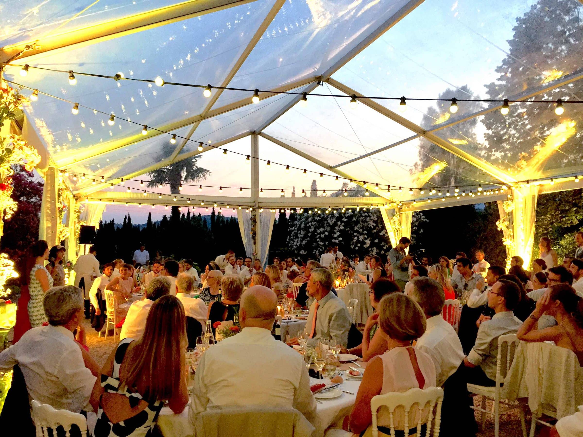 Dîner de mariage sous un chapiteau éclairé