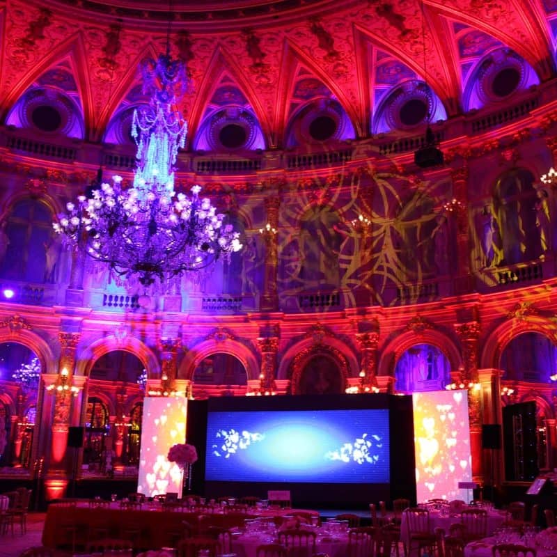 Salle de réception historique éclairée en rouge et violet